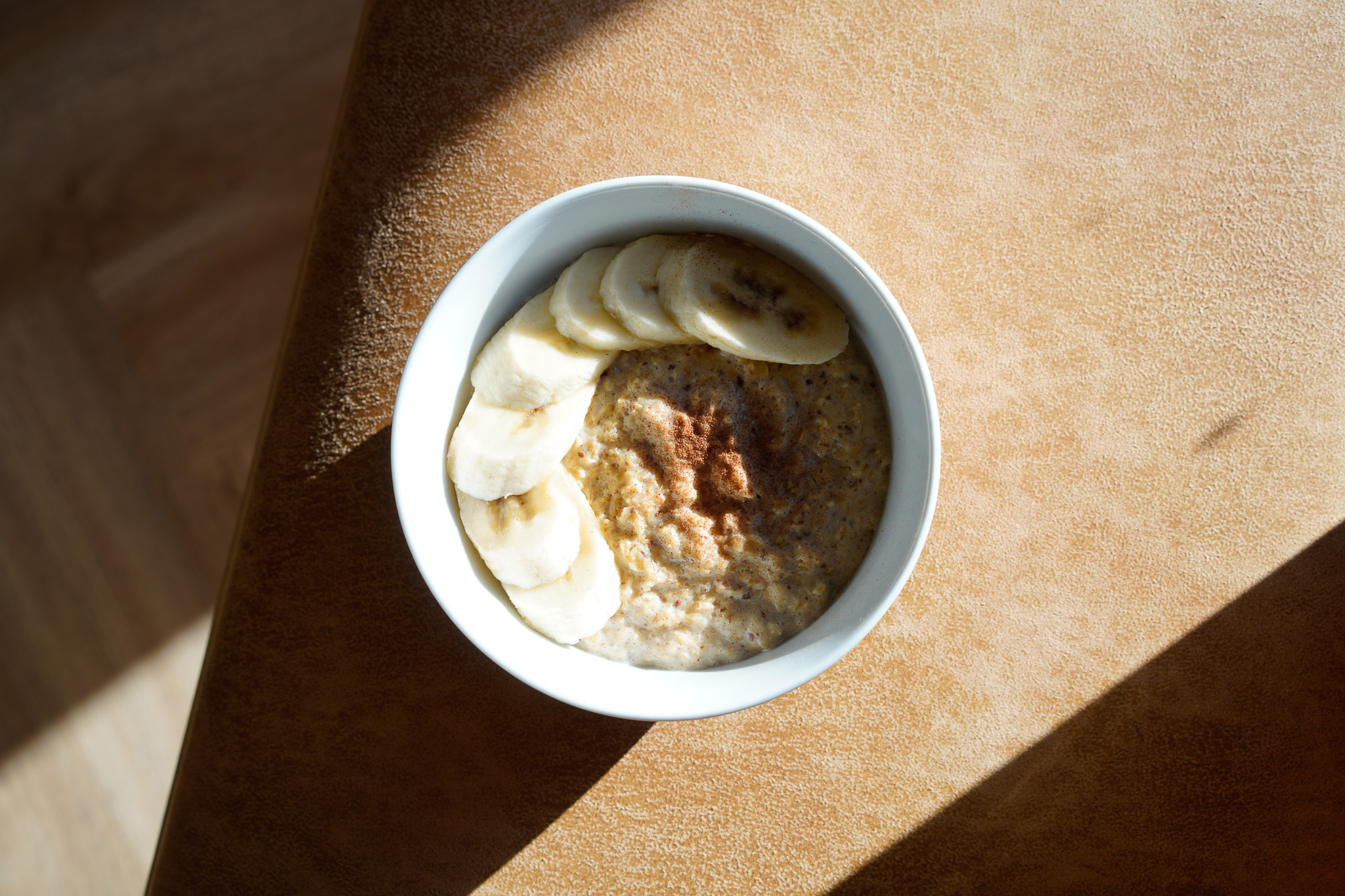 Bowl of oatmeal topped with bananas and cinnamon